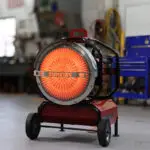 Front view of SunFire SF160 being used inside a large shop to warm employees with odorless portable heat.